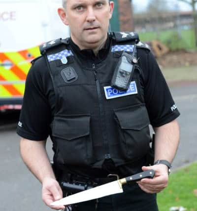 Police drug raids at Wynyard Mews. Sergeant Adrian Dack, with a knife seized as part of the operation.
