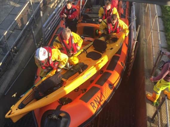 Hartlepool RNLI inshore lifeboat crew with the kayaker and kayak at the Ferry Road lifeboat station. Credit: RNLI/Tom Collins.