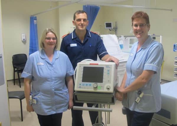 Left to right, staff nurse Emma Mitchell, Tom Bingham and staff nurse Sarah Hoggarth with the ventilator.