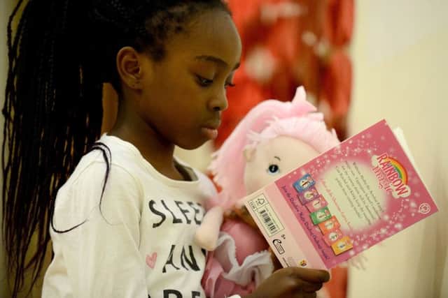 Ramat Bello reading with her doll as she takes part in the Key Stage1 bedtime story event held at St Aidans Primary school. Picture by FRANK REID