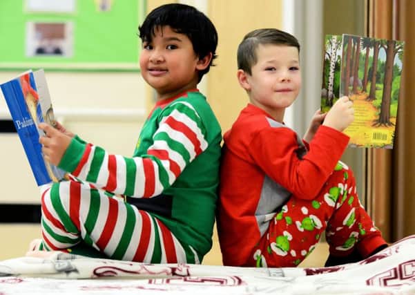 Corbeil-Essonnes Stefan Magistrado (left) and Thomas Talbot reading together at the Key Stage1 bedtime story event held at St Aidans Primary school. Picture by FRANK REID