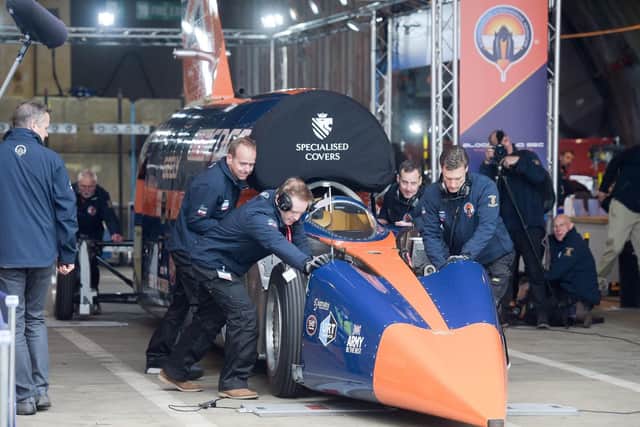 Bloodhound SSC is pushed out of the hangar by technicians at Newquay airport, Cornwall, where the supersonic car prepares to make its first run up to 200mph. Picture: Ben Birchall/PA Wire.