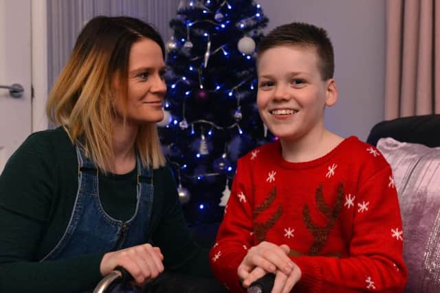 Alfie Smith, 11, with mum Annie Stalley. This is Alfie's second Christmas since undergoing life changing surgery to help him walk.