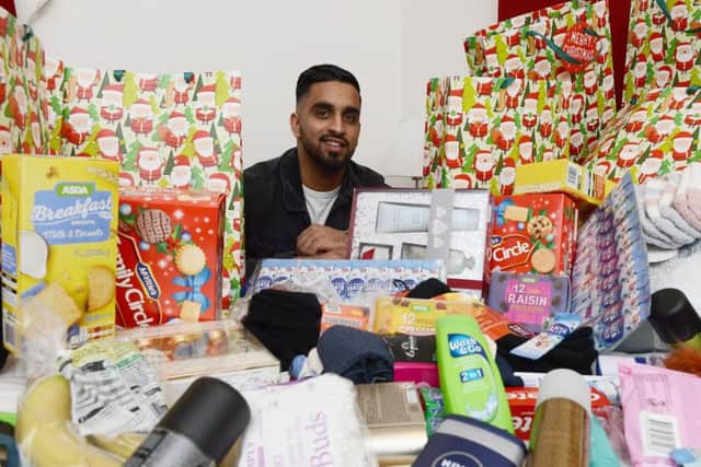 Owner of the Douglas Hotel Raqeeb Ramzan with a selection of donated Christmas gifts. Picture by FRANK REID