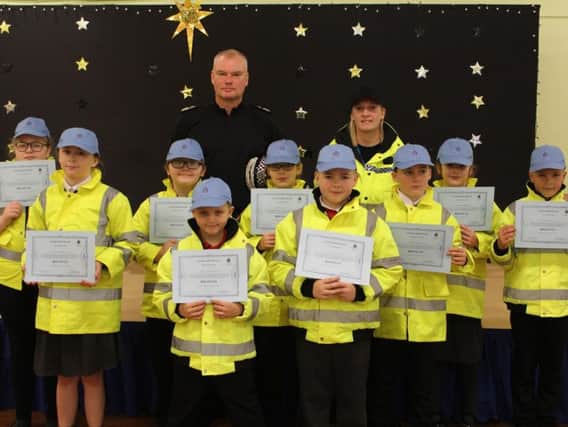 Cleveland Chief Constable Mike Veale and PCSO Lindsey Blackburn with the Mini Police from St Helens Primary School.