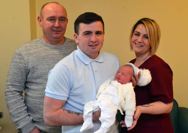 Dad Matty Kelsey with baby Lincoln William Kelsey, grandfather Jeff McNeilly and midwife Hayley Henderson.