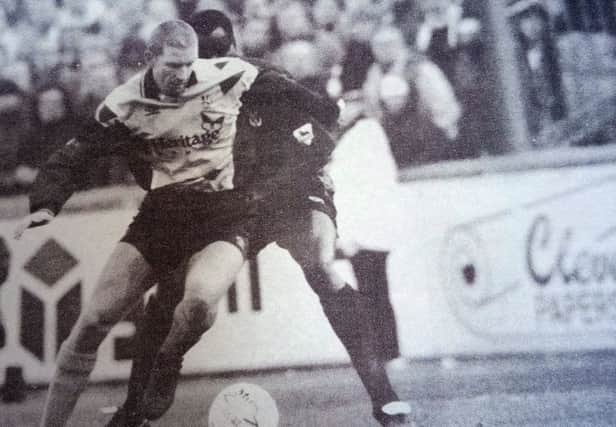 Goalscoring hero Andy Saville shields the ball from Palace player Eric  Young.