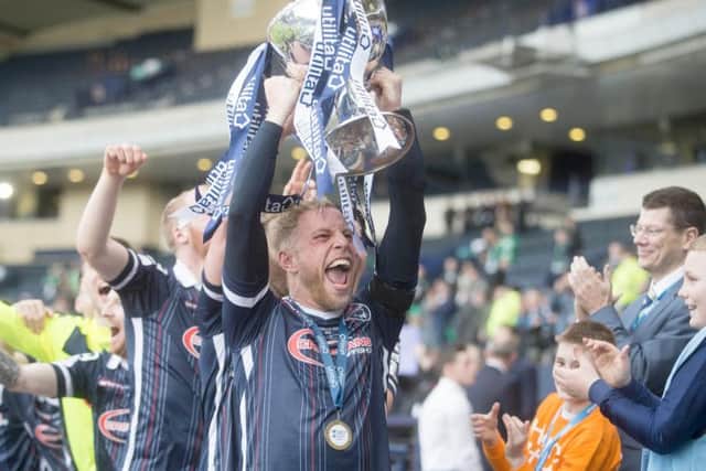 Davies lifting the League Cup in his time at Ross County in the Highlands.