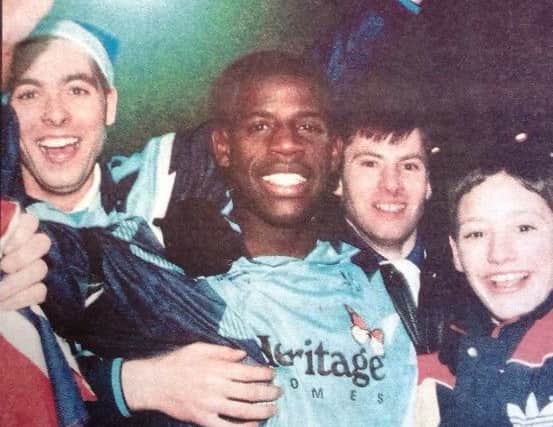 Lenny Johnrose celebrates Pools Cup win over Palace with fans.
