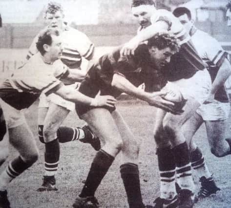 A Moseley player finds himself under intense pressure from West's forwards.