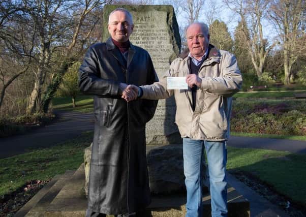 Steve Close, treasurer of History of Hartlepool group (left) receives a cheque for Â£305 from  Peter Brown of Ye Olde Durhams Social Club towards the new Boer War statue in Ward Jackson Park. 
Picture by Gary Coussons.