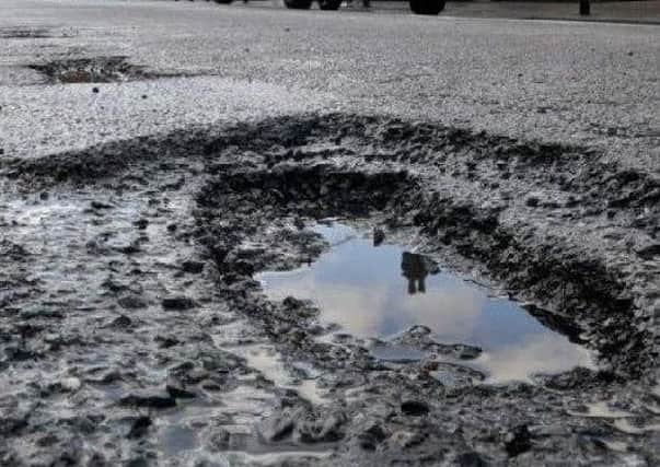 A pothole in a road.