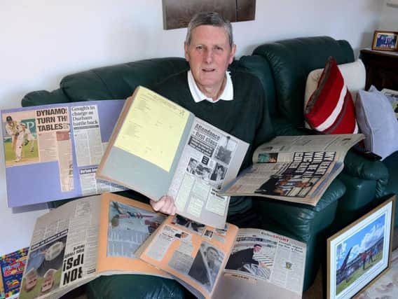 Michael Gough senior with scrapbook of memories devoted to cricketing umpire son Michael.