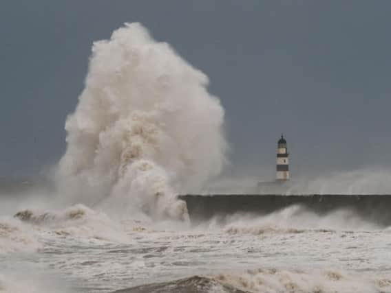 Waves crash over the North Pier at Seaham earlier today.