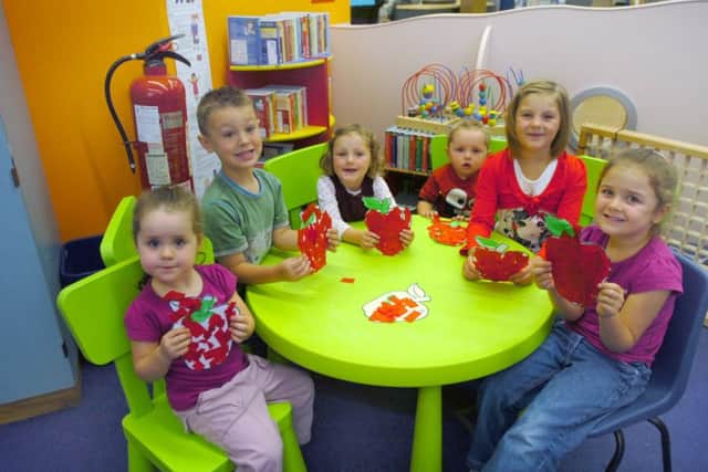 These happy children all got creative at a library session in 2009.