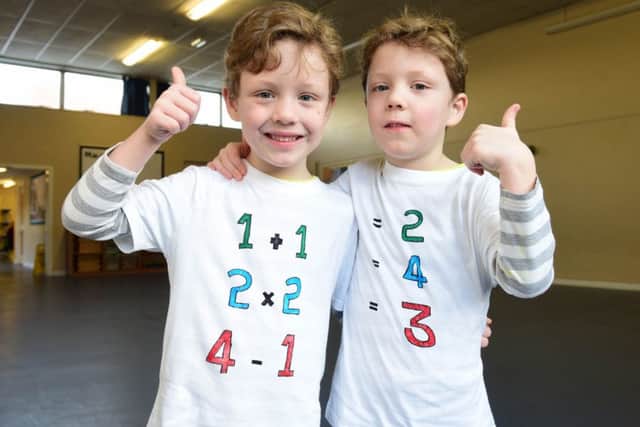 Twins Charlie (left) and Henry Simmoins-Bartlett with their special shirts for the NSPCC Number Day.