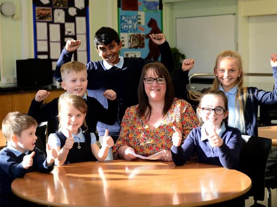 Kingsley primary headteacher Alison Darby holding a copy of their Ofsted report, with happy pupils (standing left to right) Jay Henderson, Civadhanu Kesavan and Millie Barrass (sitting left to right) Zach Gower, Isla Carruthers and Harriet Appleby.