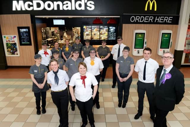 Jasper Maudsley (right) with staff outside of the refurbished McDonald's inside of Middleton Grange Shopping Centre. Picture by Frank Reid.