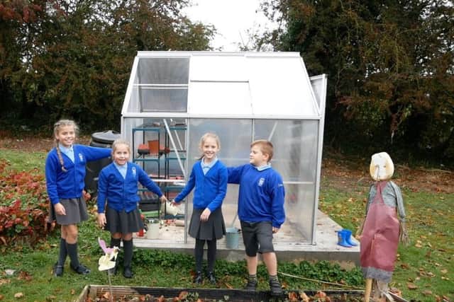 West Park Primary School pupils and their greenhouse.