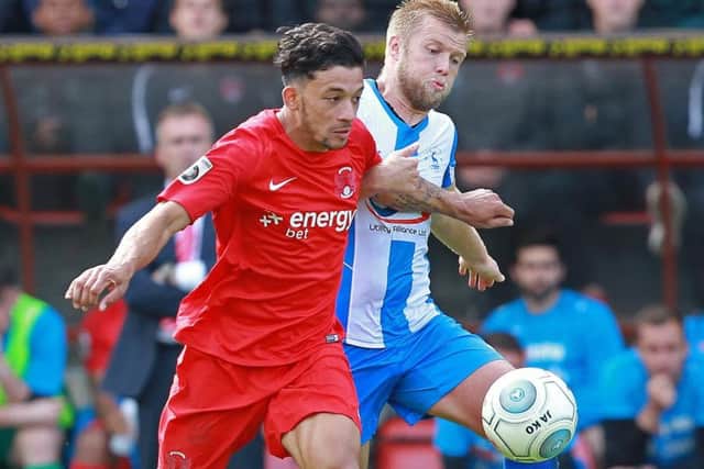 Macauley Bonne is chased by Nicky Featherstone in last season's fixture between the sides.
