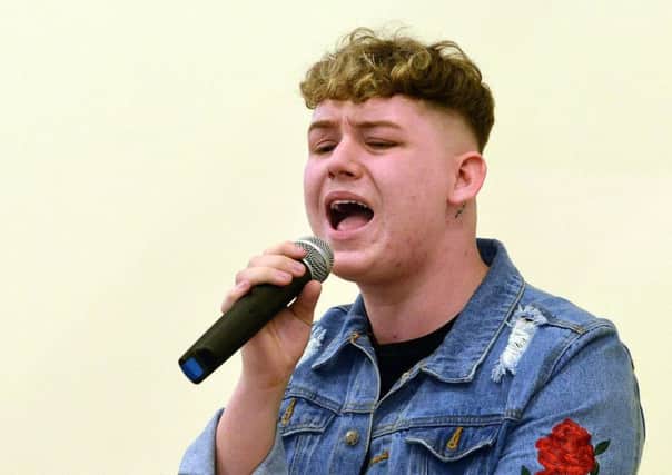 Michael Rice performing at his former school St Aidan's Primary. Picture by Frank Reid
