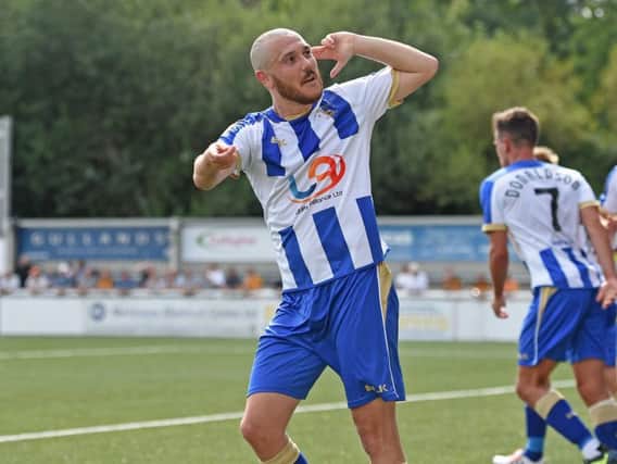 Liam Noble celebrates opening his account for Pools at Maidstone on the first day of the season.