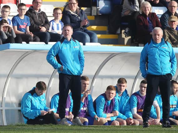 Craig Hignett is flanked by assistant Ged McNamee.