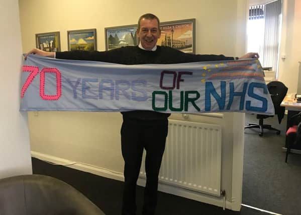 Mike Hill with the Heugh Yarners. 70th anniversary of the NHS banner.