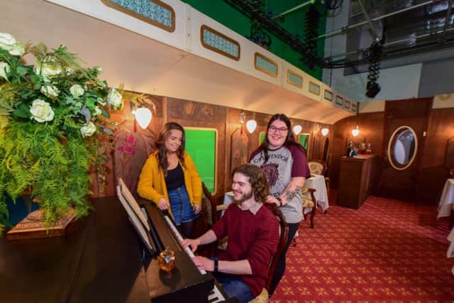 From left, students Hope Harvey, Joe Littler and Chloe Smith onboard The Northern School of Art's Hartlepool to Istanbul full-scale luxury period train carriage set at No 1 Church Street, Hartlepool.