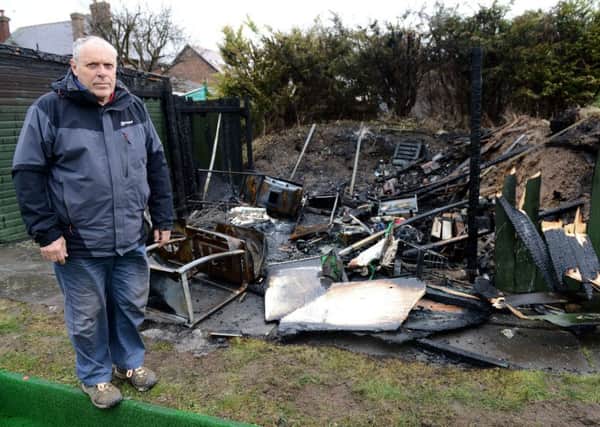 Eldon Grove Bowling and Tennis Club Chairman Tony Evans overlooks the remains of a storage shed that was destroyed in a fire. Picture by FRANK REID