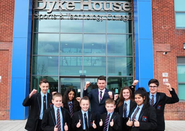 Student turned principal, Adam Palmer (back row, centre) at Dyke House Community Academy with some of his students.