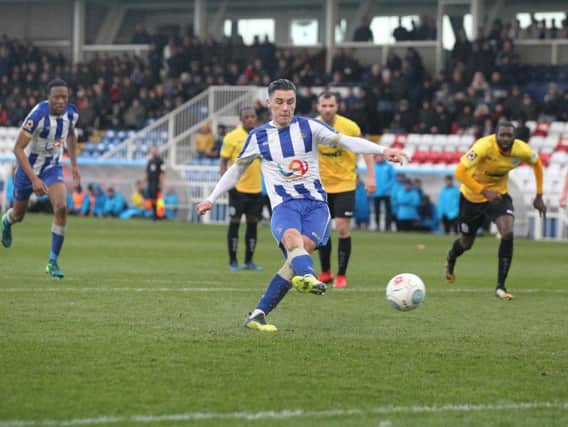Josh Hawkes slots in the second of his penalties for Pools.