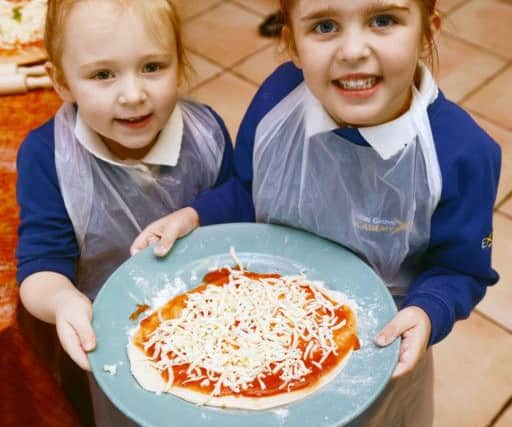 Eldon Grove Primary School pupils Frankie Bigwood (left) and Gracie McManus hold their pizza.