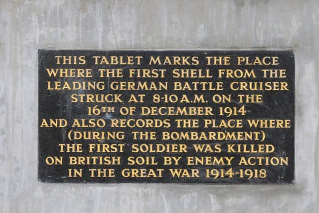 The plaque marking where the first shell fell