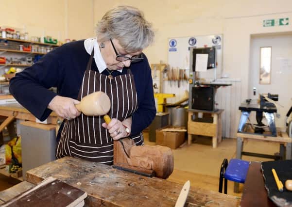 Jennifer Turner working on a carving at the Men's Shed Osborne Road. Picture by Frank Reid.