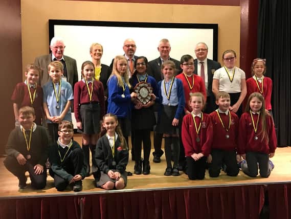 Youngsters from the five schools who took part in the Public Speaking Competition are pictured with the judges.