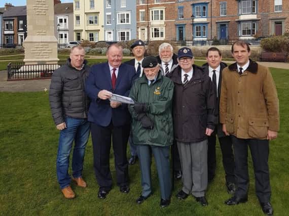 Councillor Allan Barclay (second from the left) looks at plans for the new path with (from left) Dawson Landscapes Managing Director Andrew Dawson and local Armed Forces veterans Ian Fraser, Dave Murray, Barry Fishburn, Chris Ward, Daniel Threadgill and Mike Facchini.