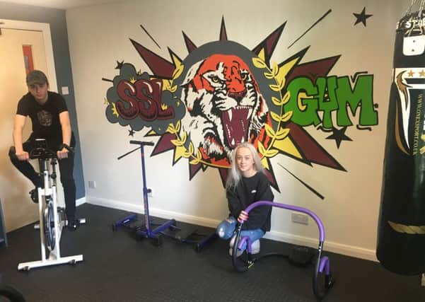 Gym opens at Hartlepool homeless service. Residents Curtis Duke and Amy Summers try out the new equipment.