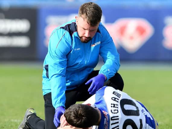 Aaron Cunningham receives treatment after suffering a knee injury.