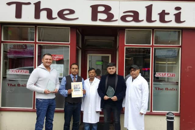 Co-owners Ashraf Khan and Afzal Khan, with chef Ubed Ahmed, customer assistant Nayeem Khan and customer Luke Gooding.