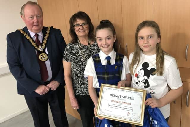 Councillor Allan Barclay and Alice House Hospice's Janice Forbes with pupils of St Peter's Elwick C of E Primary School receiving their Bronze Award.