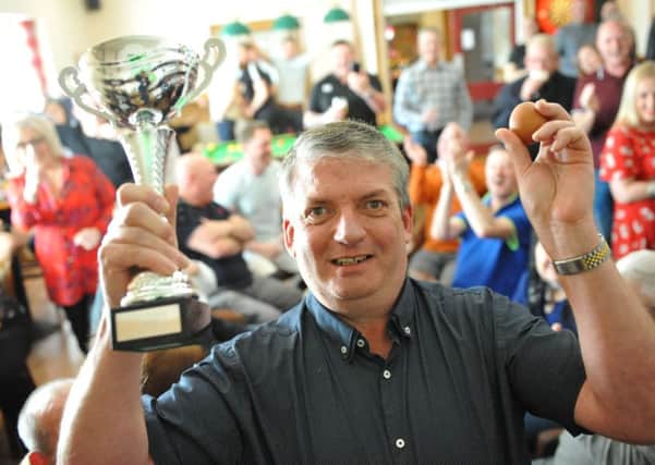 Andy Dudgeon with the trophy he won at the World Egg Jarping Championship at the Hearts of Oak, Peterlee.
