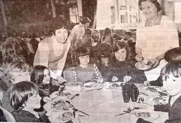 Children at West Park Junior and Infants School tuck into a tasty meal in 1975.