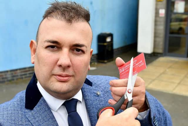 Councillor Stephen Akers-Belcher cuts his Labour membership card in half after resigning from the party. Picture by Frank Reid.
