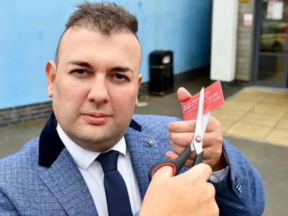 Stephen Akers-Belcher cutting up his Labour Party membership card.