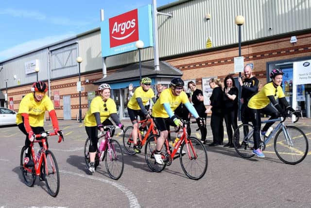 Gemma Hewitson, right, and fellow riders Tim Worth, Mark Ramshaw, Megan Fawkes and Stephen Fulton are cheered on by staff from Boots and Exercise4less as they take part in the sponsored ride In aid of Zoe's Place.