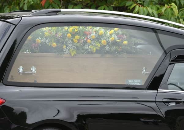 A hearse carrying a coffin. Picture by PA