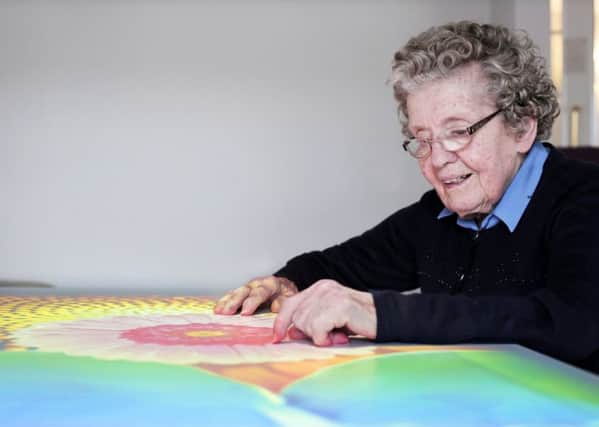 Elwick Grange care home resident Audrey Hamilton tries the dementia table. Photograph: Stuart Boulton