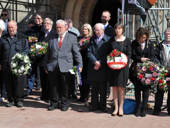 Guests at the Workers Memorial Day service in Hartlepool gather to lay wreaths.