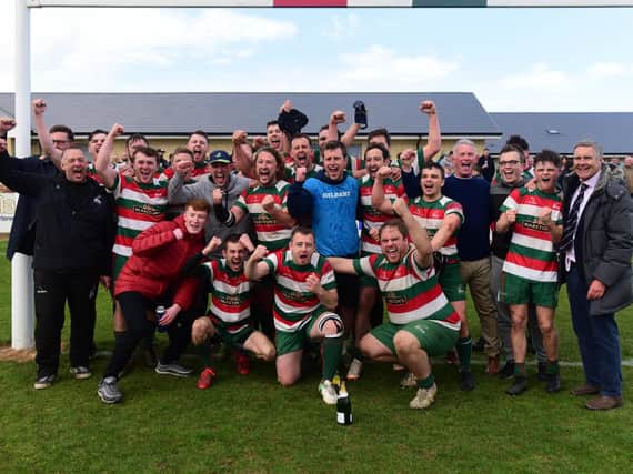 West Hartlepool players and coaching staff celebrate their promotion success.